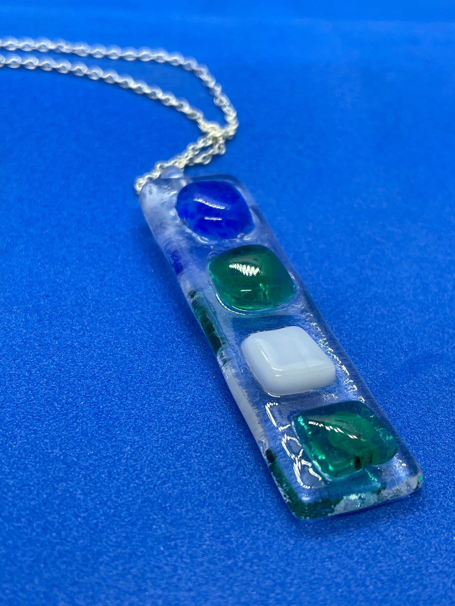 Fused clear glass with blue, green, and white squares oblong earrings