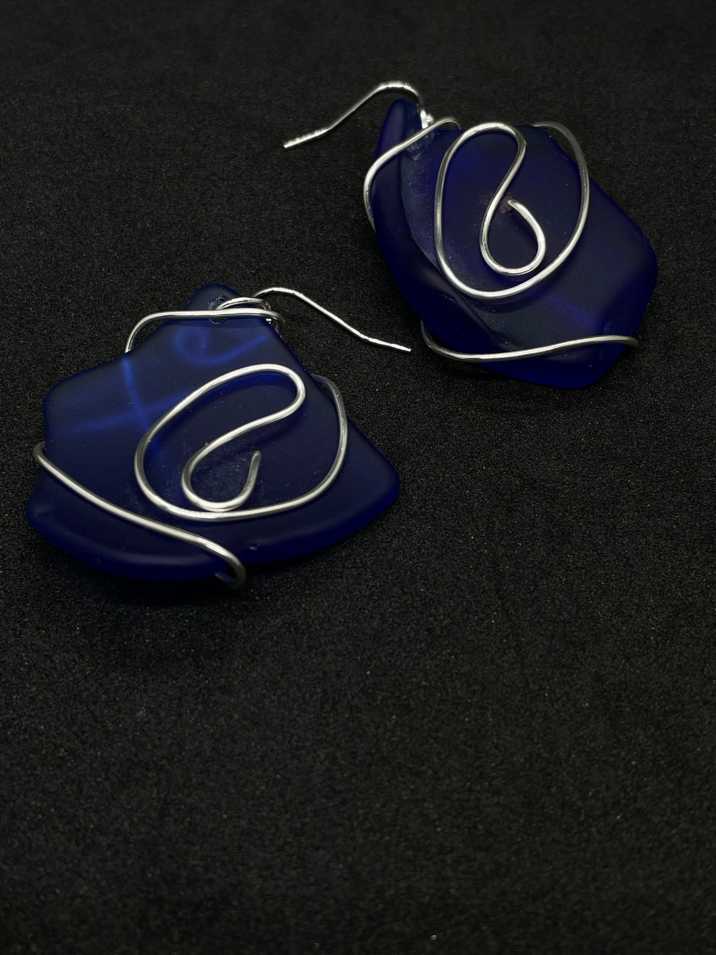 Blue Seaglass entwined in silver wire twists drop earrings