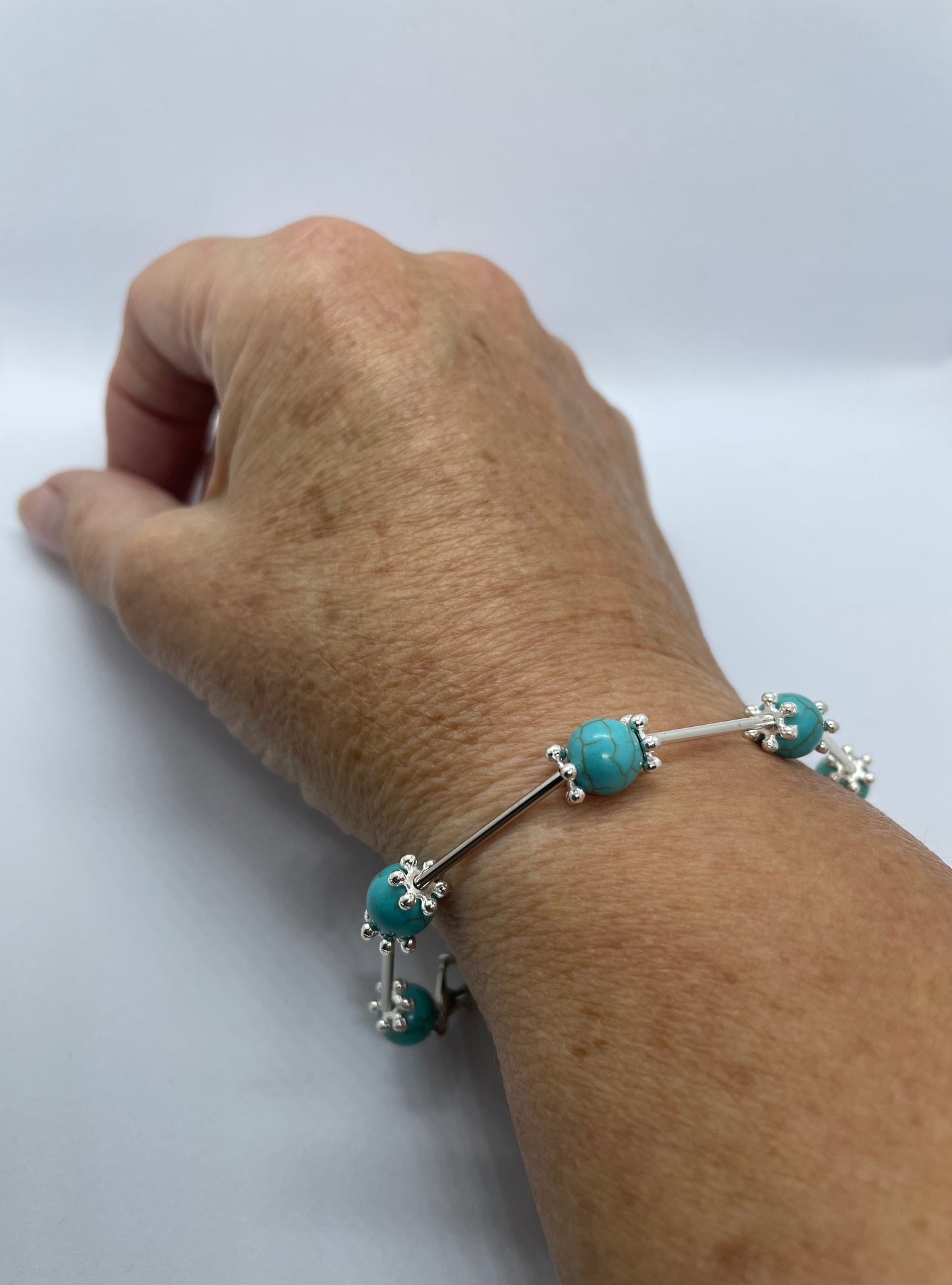 Wire & turquoise bead bracelet with silver rod spacers