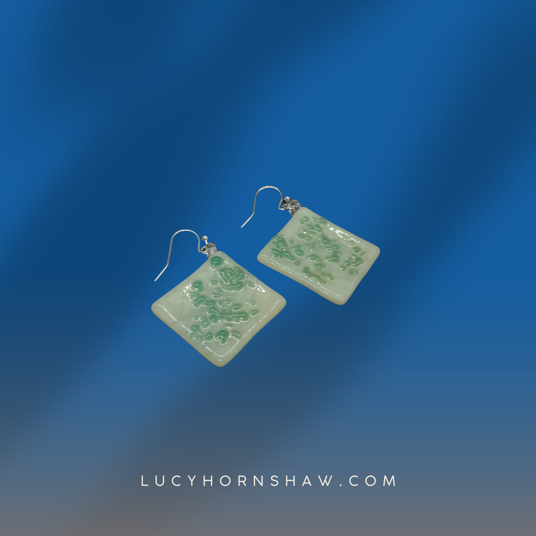 White and green rhombus fused glass earrings.