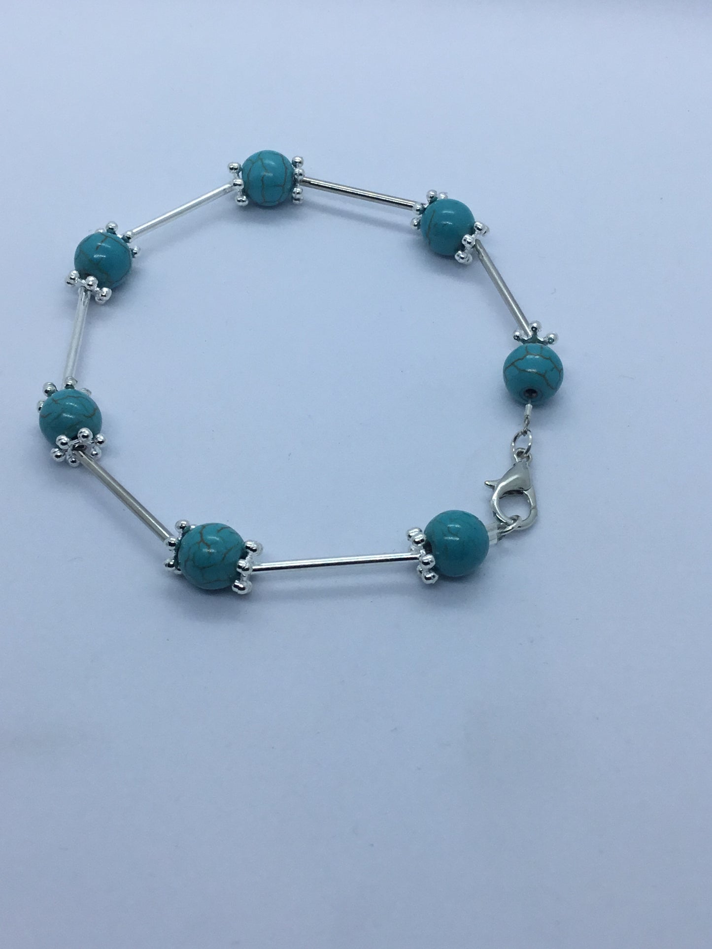 Wire & turquoise bead bracelet with silver rod spacers