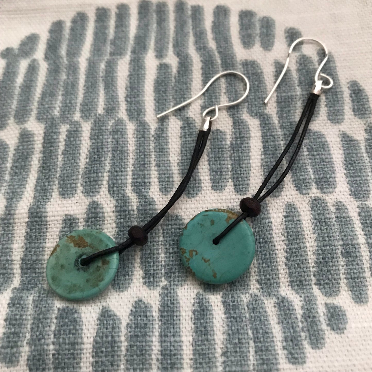 Turquoise bead on black leather cord earrings