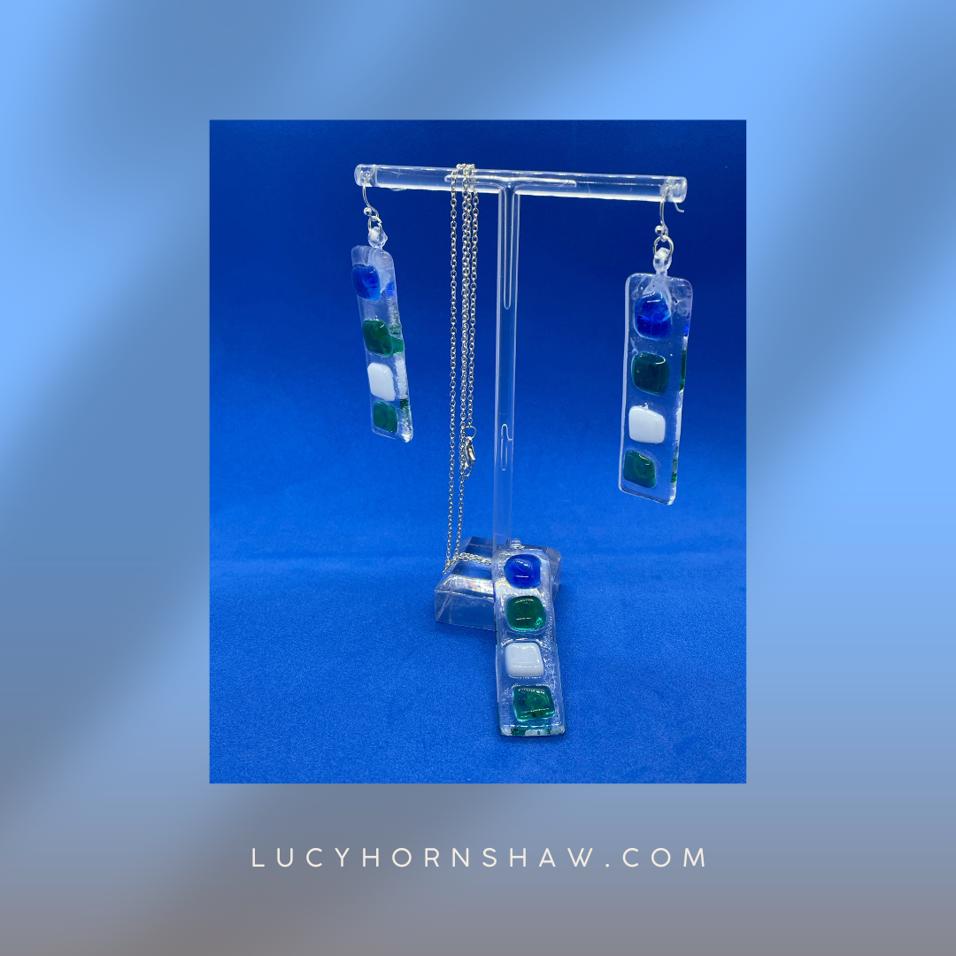 Fused clear glass with blue, green, and white squares oblong necklace