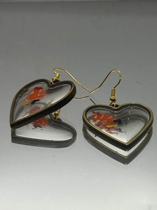 Gold heart drop earrings with orange and black detail