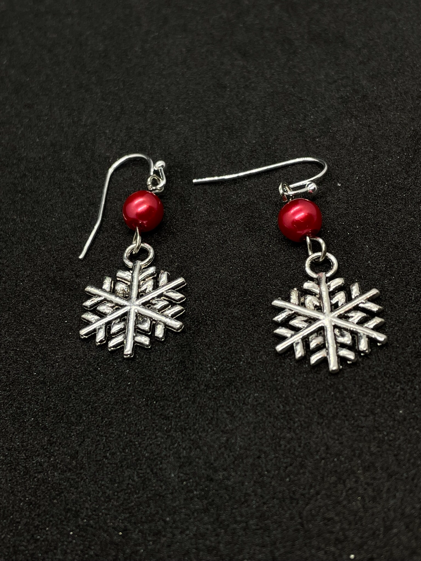 Festive snowflake dangling from bead, drop earrings
