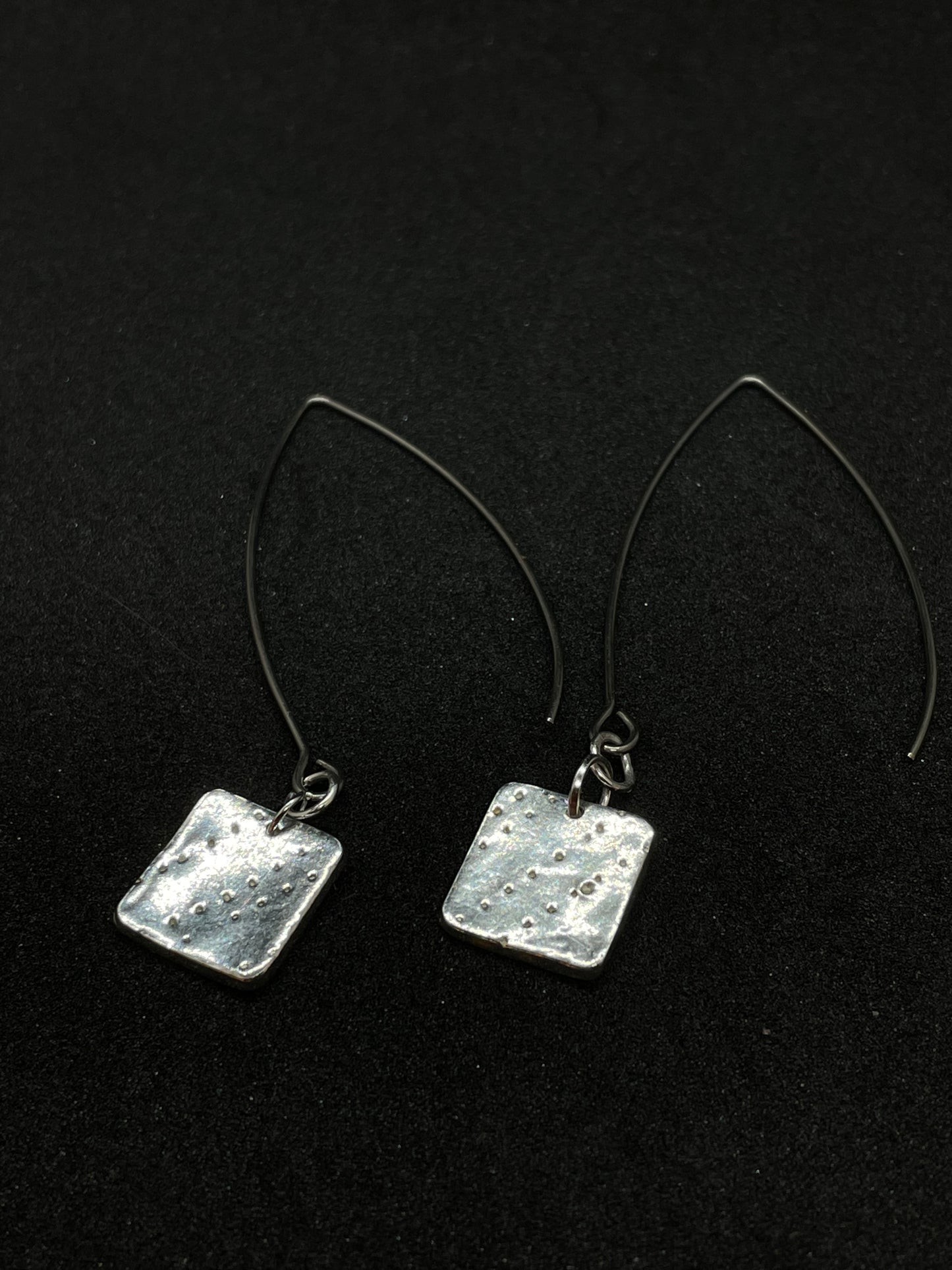 Silver rhombus earrings on long wire drop