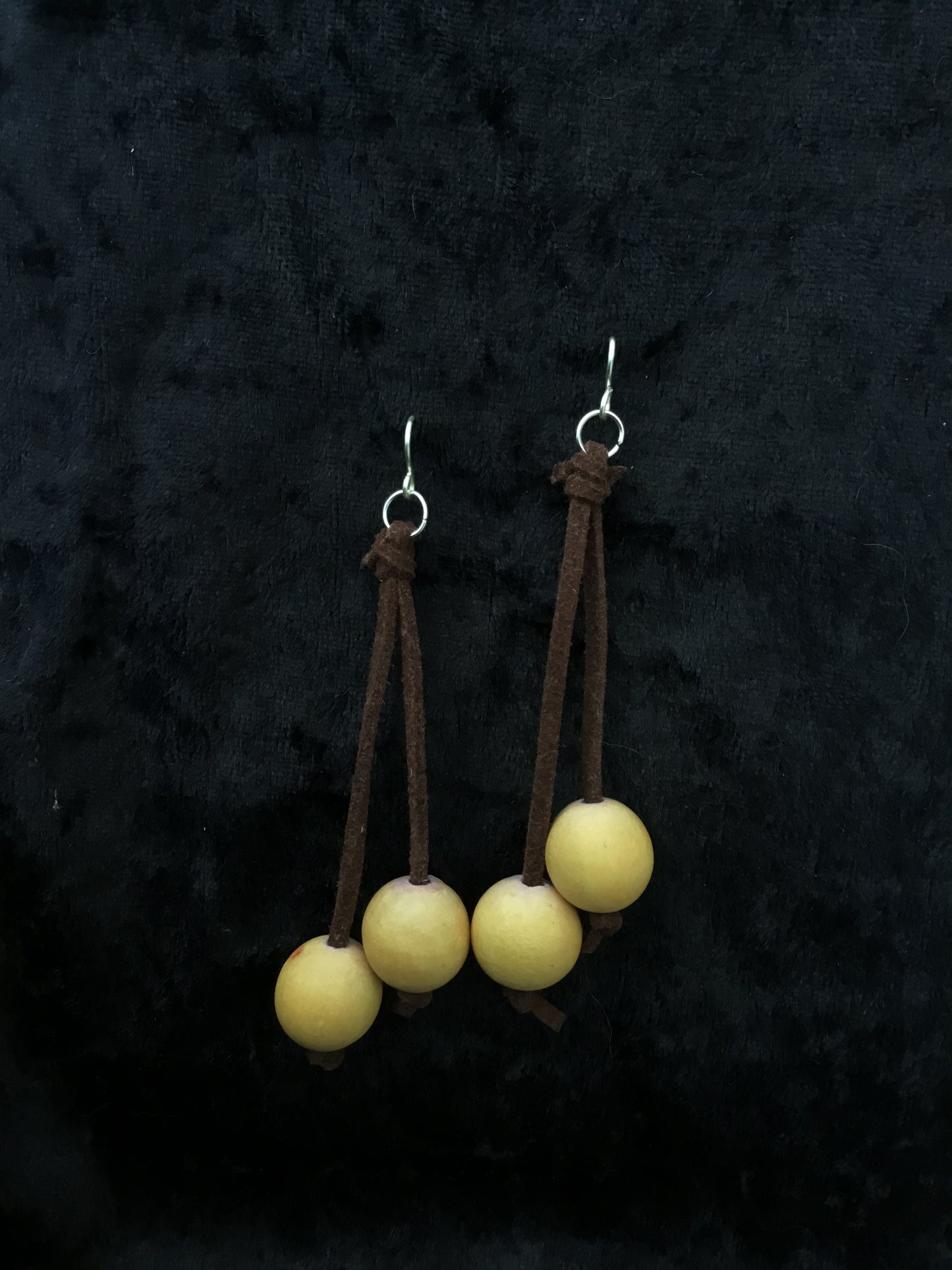 Wooden cream bead on brown leather thong earrings