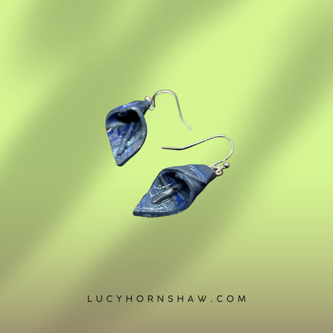 Blue lily shaped polymer clay drop earrings with a 2.5cm drop.