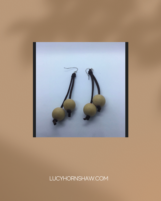 Wooden cream bead on brown leather thong earrings