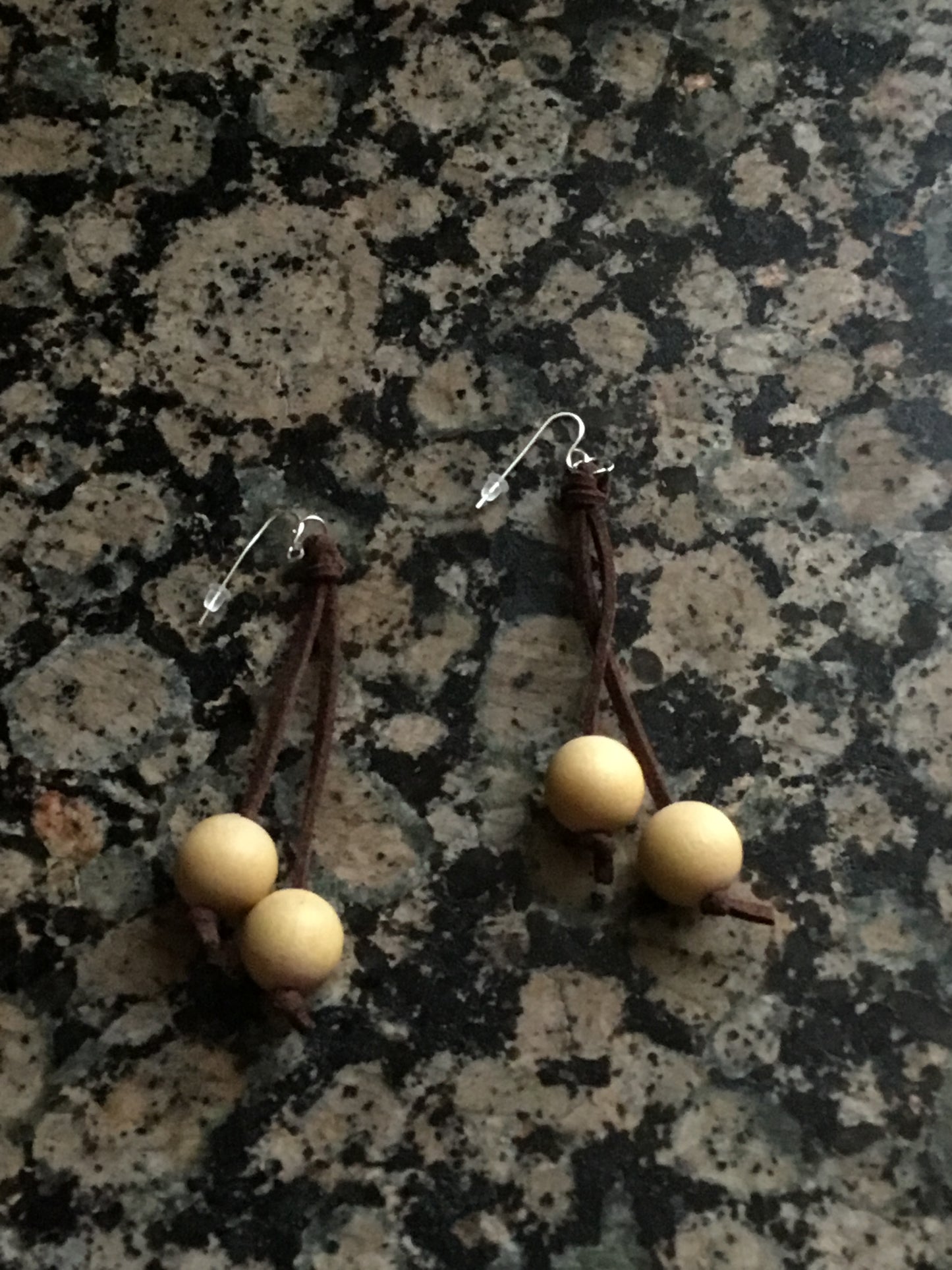 Wooden cream bead on brown leather thong earrings