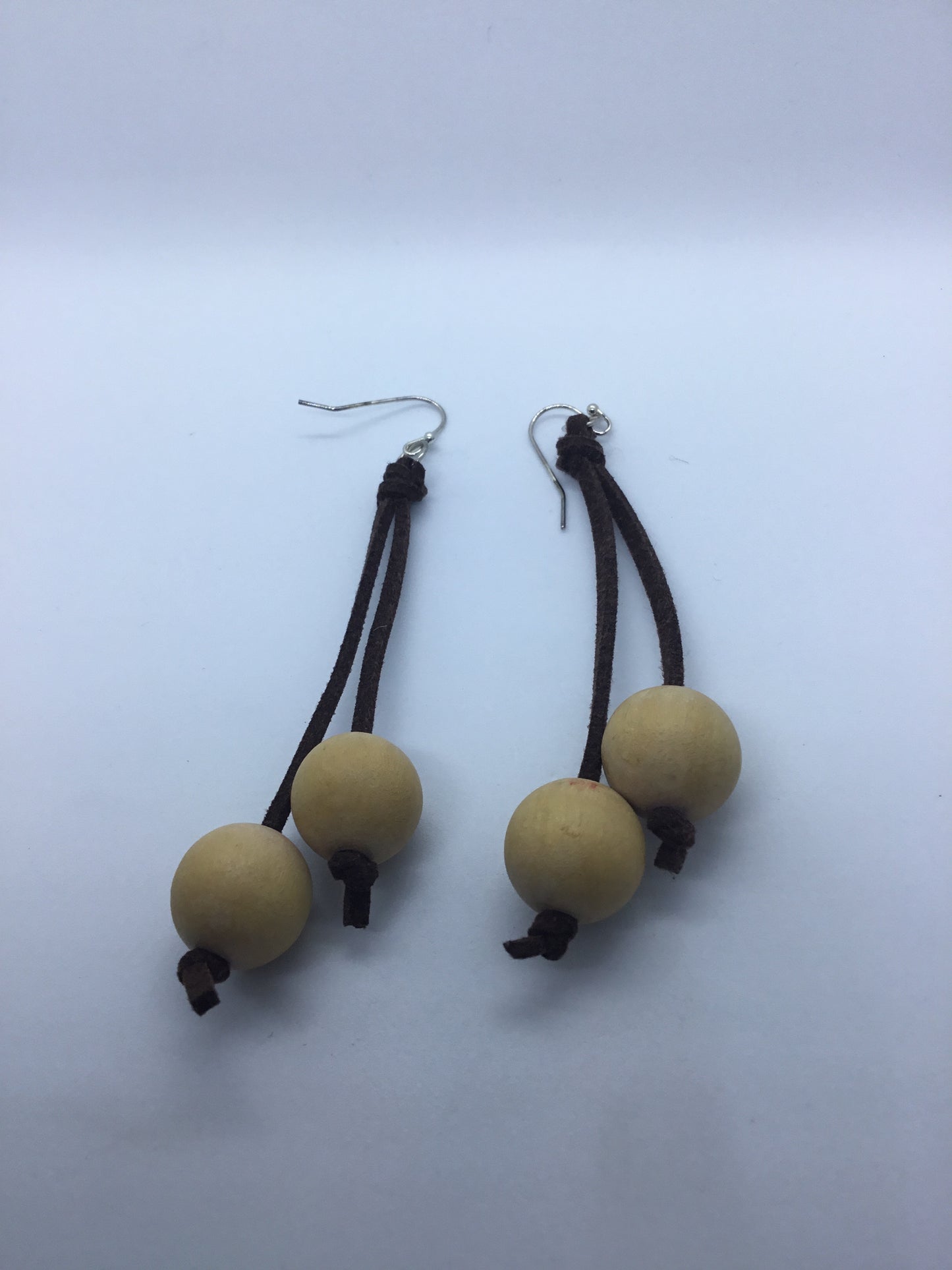 Wooden cream bead on brown leather thong earrings